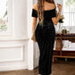 Elegant black velvet midi dress styled for weddings or evening parties.
