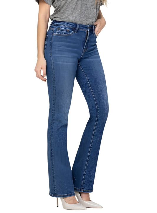 Women wearing medium-wash bootcut jeans paired with white heels.
