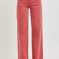 Women's high-rise jeans with tummy control, styled with white pointed-toe heels.
