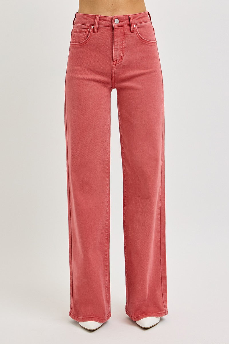 Women's high-rise jeans with tummy control, styled with white pointed-toe heels.
