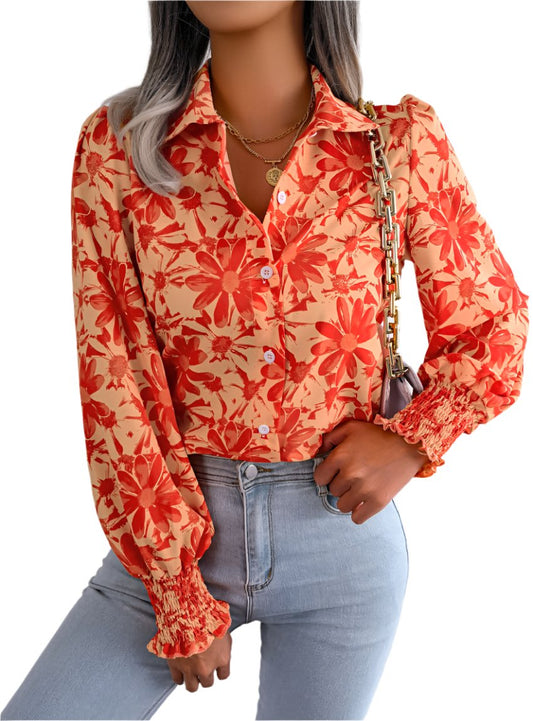 Woman wearing an orange floral button down shirt with smocked cuffs
