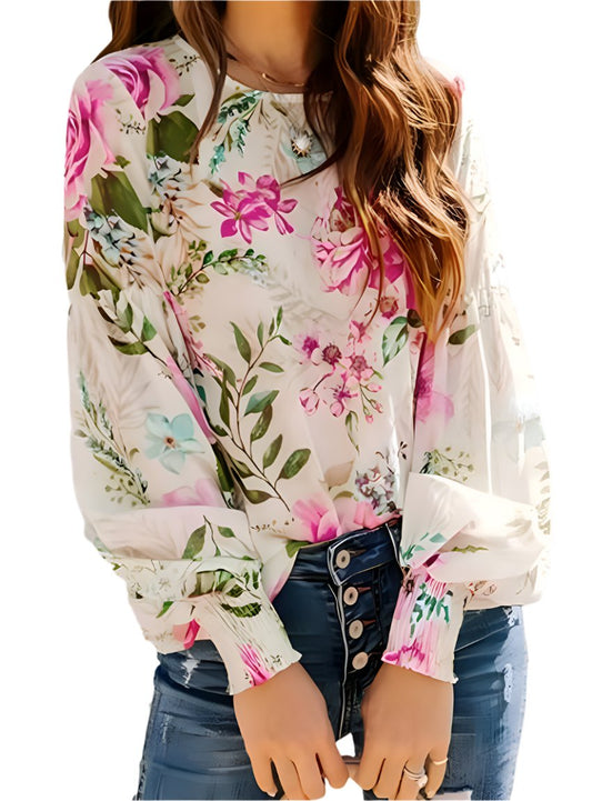 Woman wearing a vibrant floral button down shirt in pink and green tones
