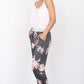 Side view of floral jogger pants with drawstring waist and cuffed ankles
