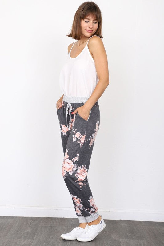 Side view of floral jogger pants with drawstring waist and cuffed ankles
