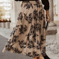 Semi-sheer khaki midi skirt featuring black embroidered floral design.
