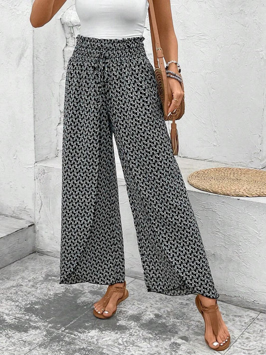 Waistband and drawstring closeup on black wide-leg floral pants
