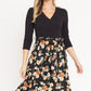 Black floral wrap midi dress with 3/4 sleeves and tie waist.
