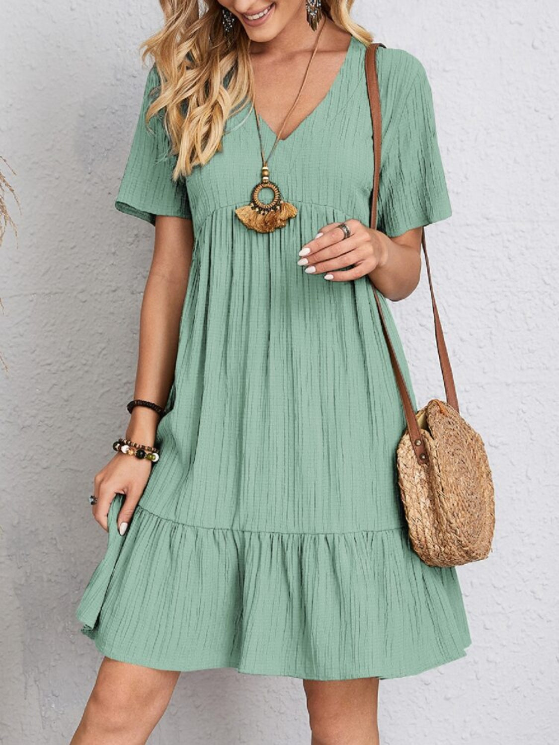 Relaxed fit green dress with playful tiered design