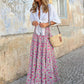 Flowy pink boho maxi skirt styled for casual summer outings or vacations.
