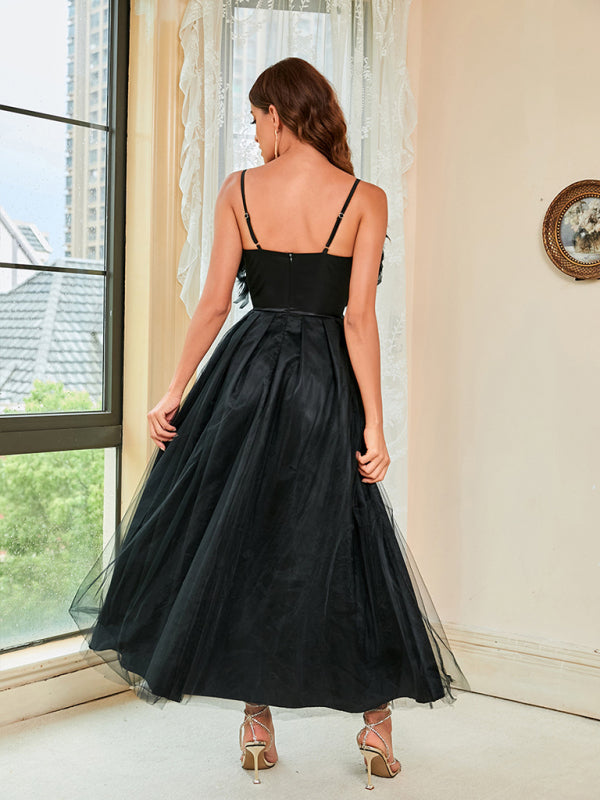 Full-length image of a sleeveless black dress with a voluminous tulle skirt.
