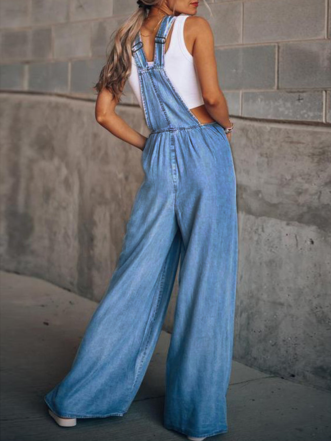 Trendy wide-leg denim overalls in light wash for women’s casual style.
