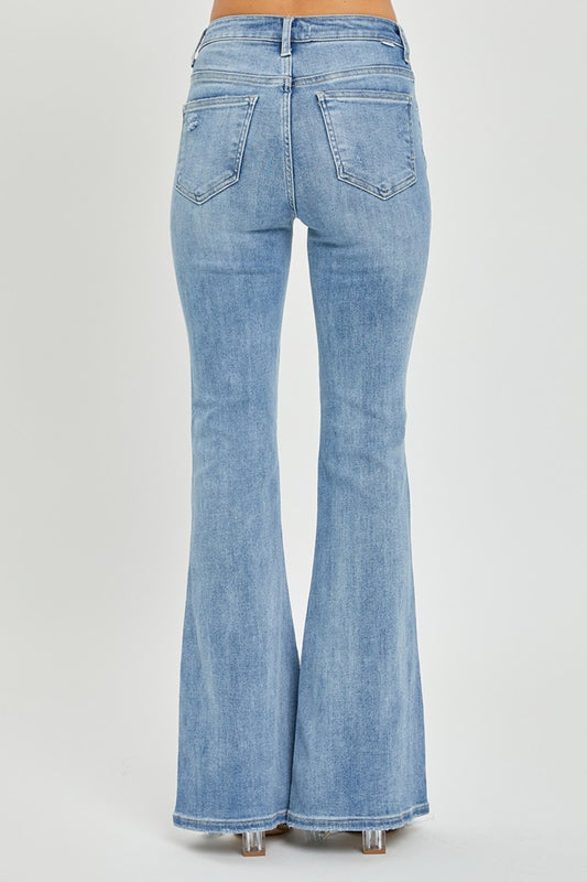 Women's frayed hem high rise flare jeans by RISEN in light wash.
