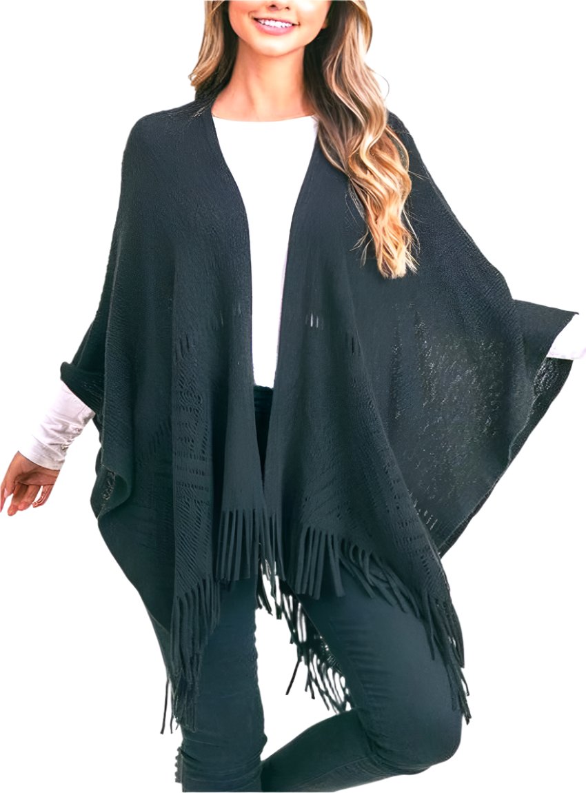 Woman wearing black fringe hem knit shawl over white top.
