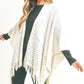 Neutral knit shawl with fringe hem for easy fall and winter layering.