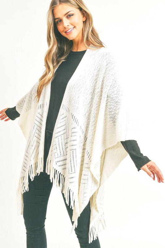 Neutral knit shawl with fringe hem for easy fall and winter layering.