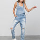 Close-up of light wash patch pocket ripped overalls for a trendy, relaxed style.
