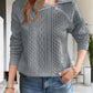 Full-length view of a gray cable knit quarter-zip sweater, great for layering with casual outfits.

