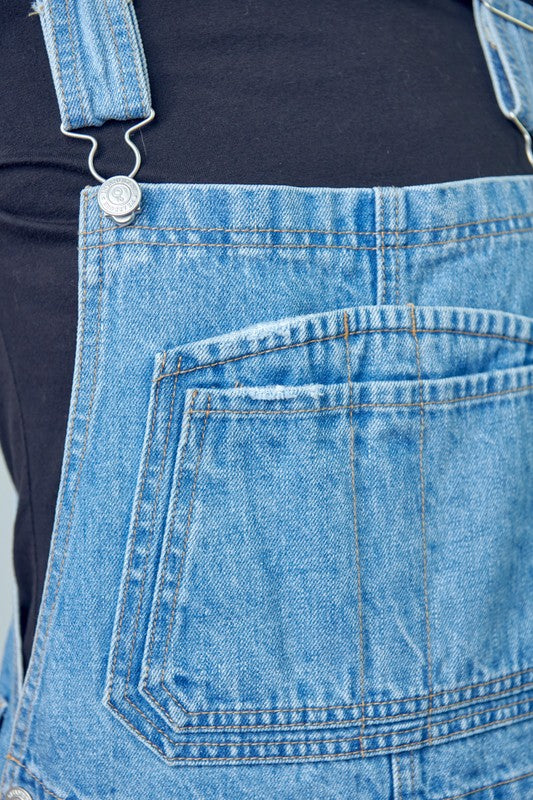 Adjustable strap high-waist denim overalls featuring side button closure.
