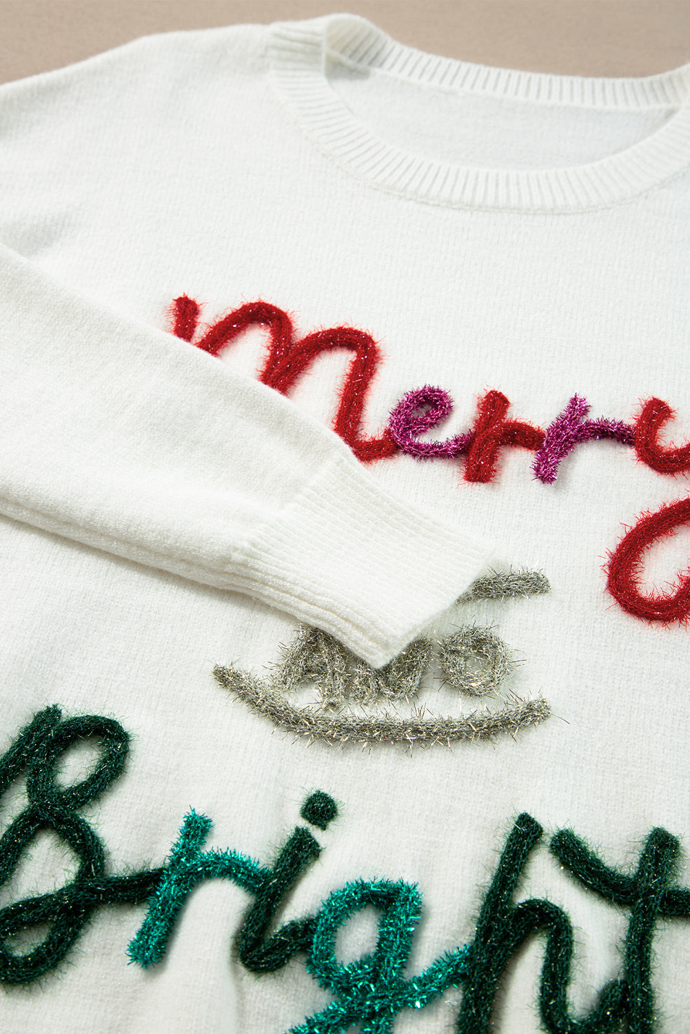 Fun holiday sweater featuring "Merry & Bright" in colorful tinsel lettering, perfect for casual winter outfits and Christmas events.