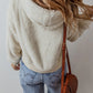 Women's fuzzy beige hoodie with dropped shoulder sleeves, casual style.
