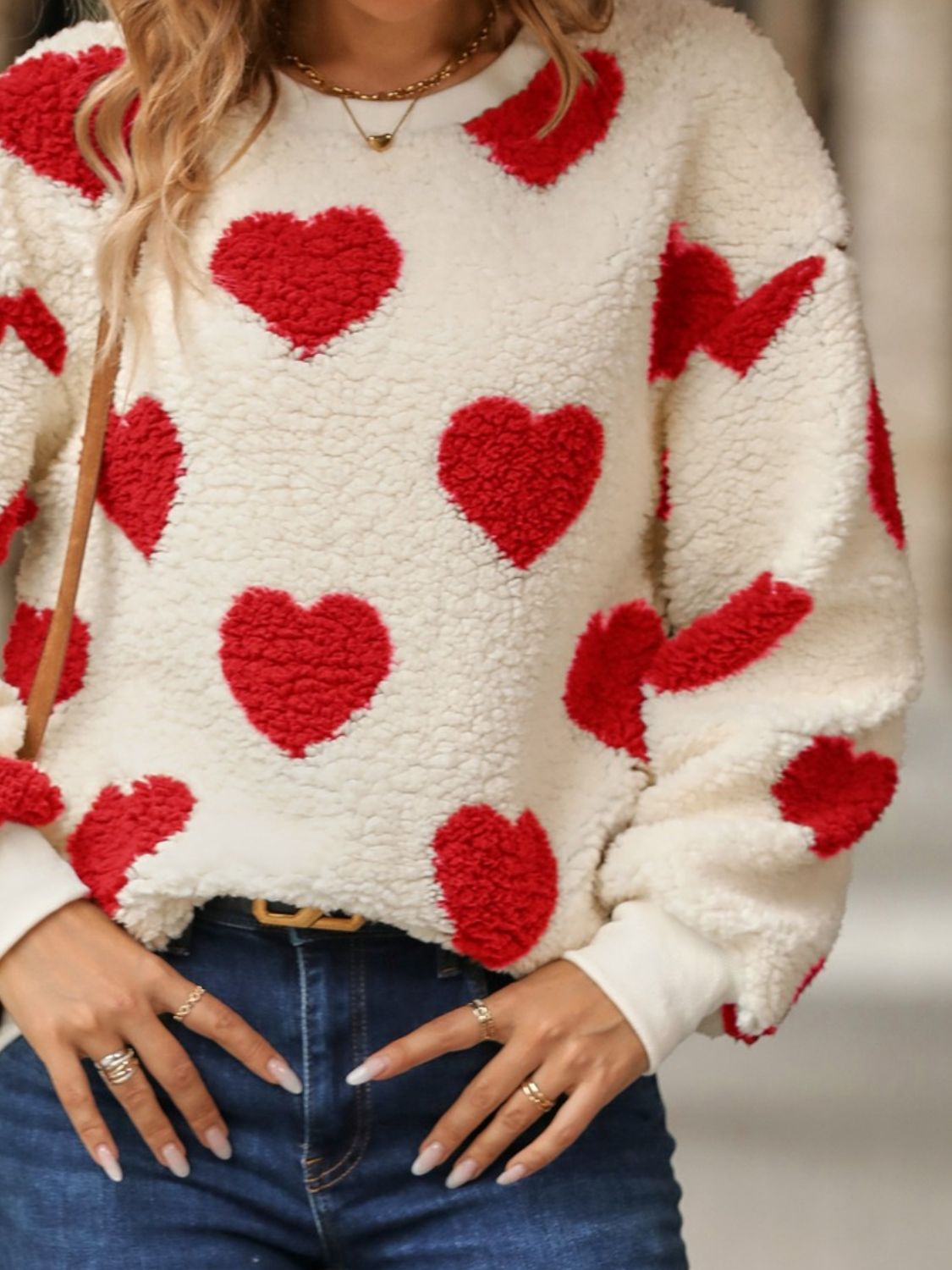 Red fuzzy heart sweatshirt worn casually for a warm, cozy look