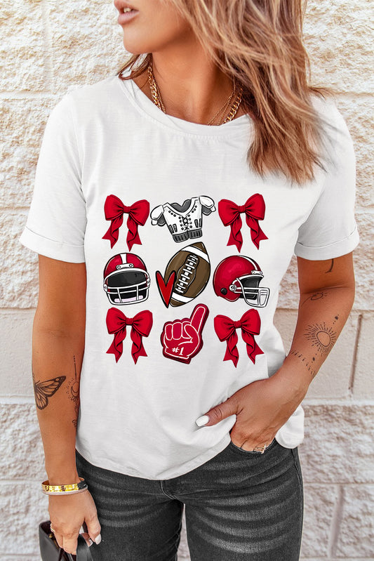 White t-shirt with red football helmets, a football, and bows graphic.