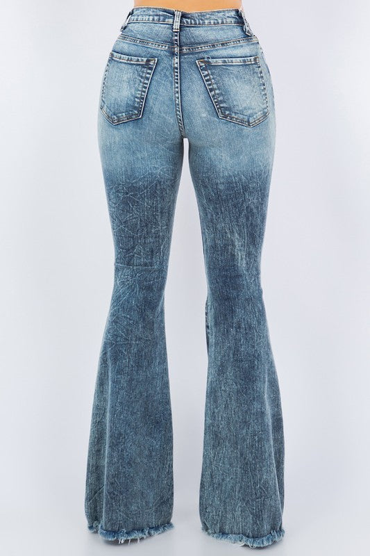 Comfortable high-rise bell bottom jeans with rips and vintage look.
