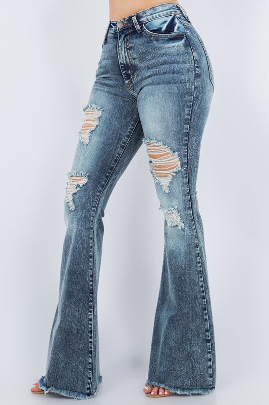 Distressed bell bottoms with a frayed hem, made from stretchy denim.
