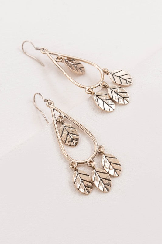 Lightweight gold hook earrings featuring delicate leaf charms for casual and elegant wear.
