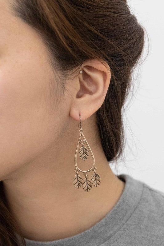 Gold-plated dangling leaf earrings perfect for adding a bohemian touch to your outfit.
