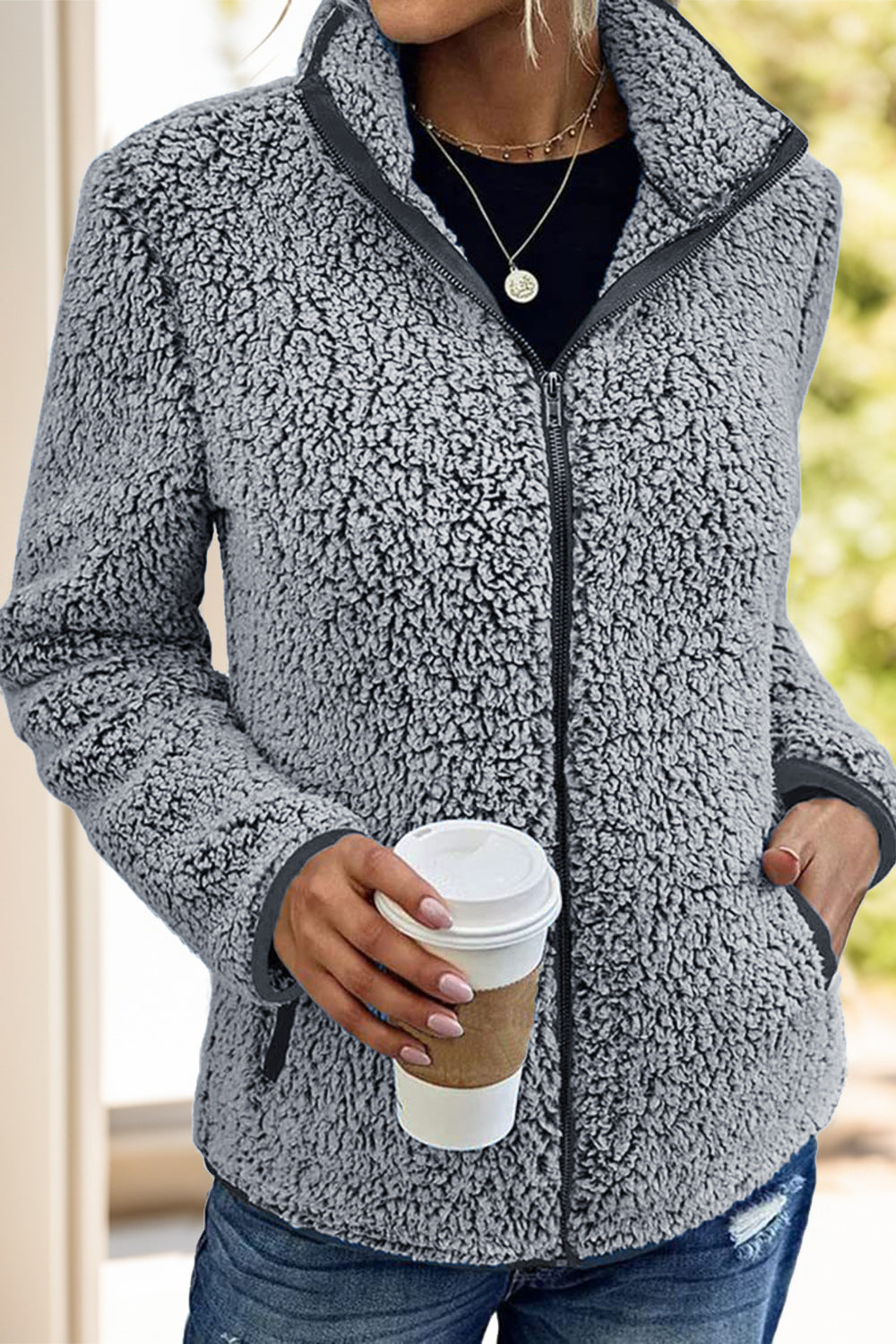 Gray fleece sherpa jacket for women, ideal for chilly weather and casual layering.
