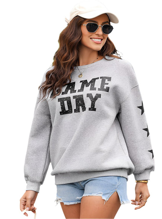 Gray "Game Day" sweatshirt with bold lettering and star sleeve details.