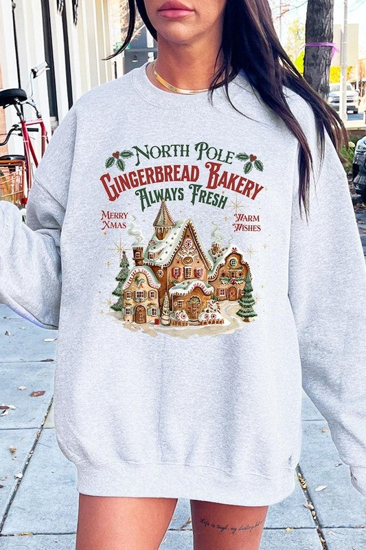 Cozy gray sweatshirt with North Pole Gingerbread Bakery graphic, perfect for holiday gatherings.