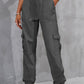 Gray high-waist pants with pockets for a stylish and practical design.
