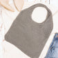 Gray soft-knit hobo bag with lightweight construction and durable design.
