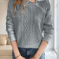 Cozy gray knit quarter-zip sweater styled for layering with a casual winter outfit.

