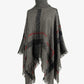 Gray turtleneck poncho with classic plaid print and fringe.
