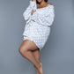 Woman wearing a gray polka dot plush robe with a belted waist, perfect for lounging.
