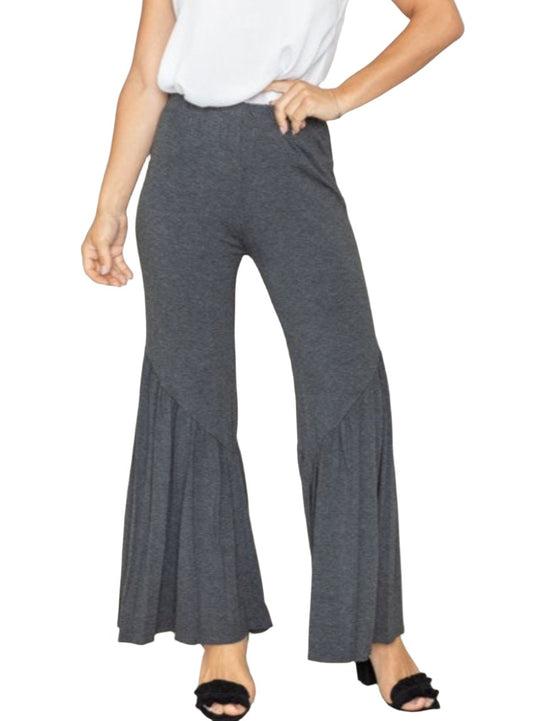 Woman wearing gray ruffle hem pants with a high-waisted fit
