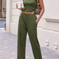 Woman in a green 3-piece women's pant suit with wide-leg pants and a duster jacket
