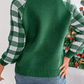 Full-length view of a green knit sweater with a white reindeer graphic and plaid sleeves, ideal for winter wear.