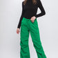 Green cargo pants styled casually with a relaxed fit for everyday wear.
