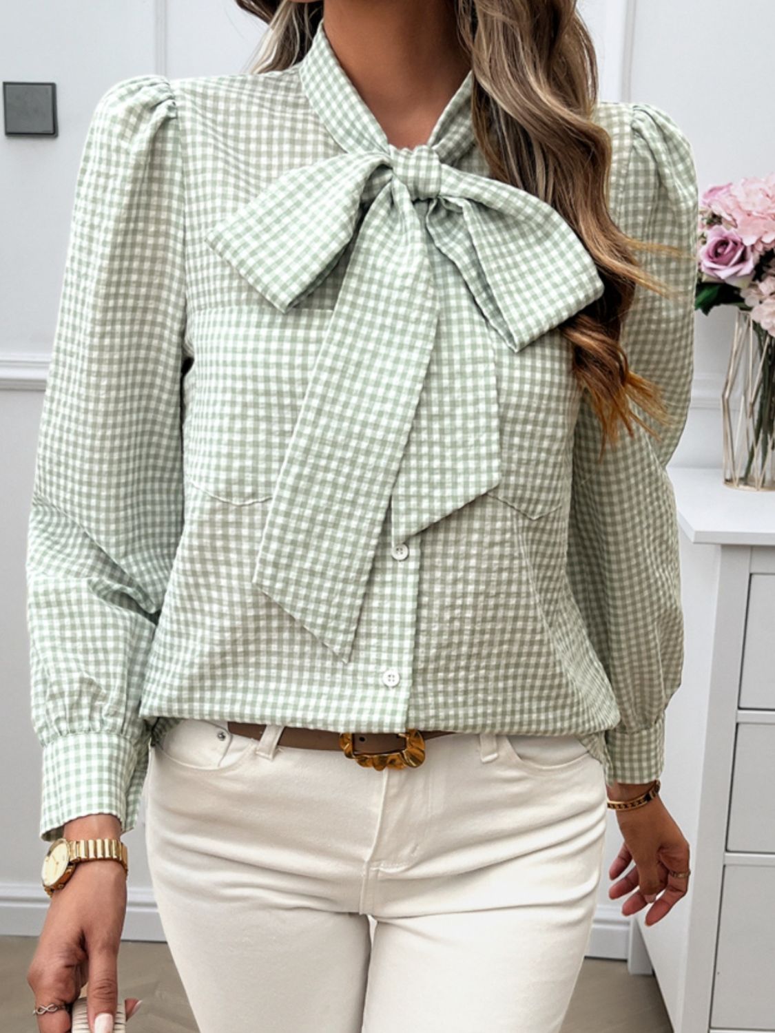 Green gingham puff sleeve blouse with a bow tie, styled for work or casual wear.
