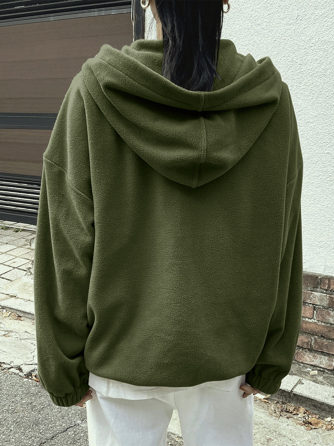 Woman in a green fleece pullover, ideal for casual outings.
