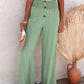 Green high-waisted wide-leg pants with elastic waistband and relaxed fit.