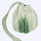 Green jacquard bucket bag showcasing tassels and a comfortable strap.
