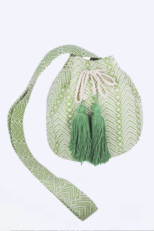 Green jacquard bucket bag showcasing tassels and a comfortable strap.
