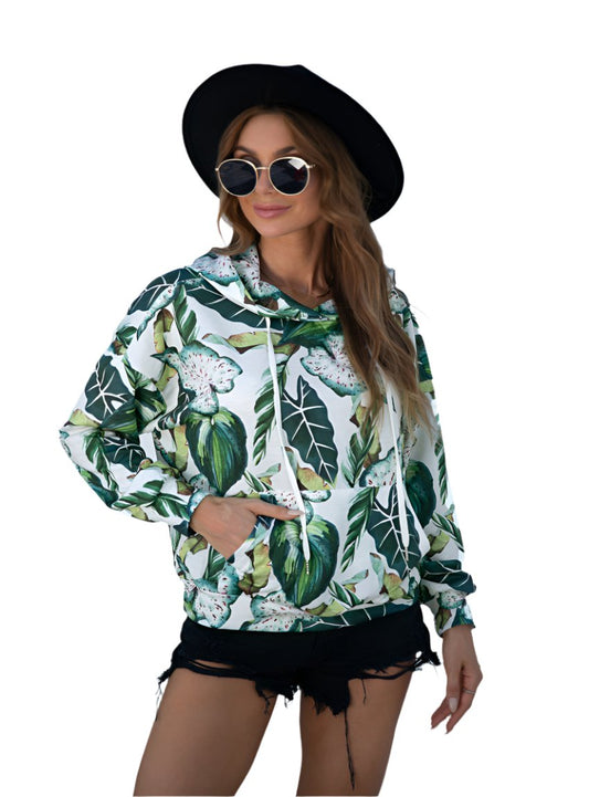 Front view of a green hoodie with a vibrant botanical leaf print.
