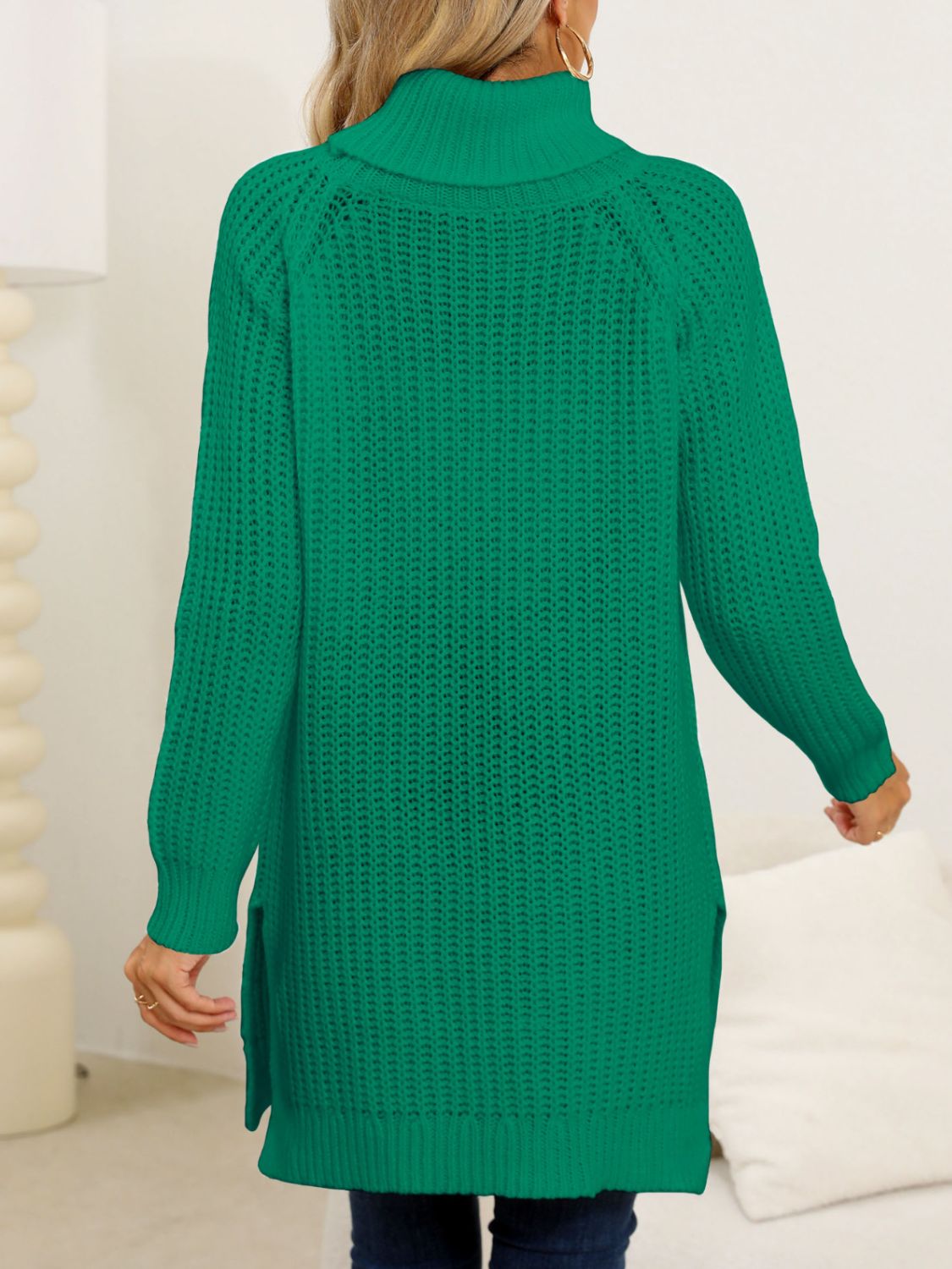 Green winter pullover with a turtleneck and slit details.
