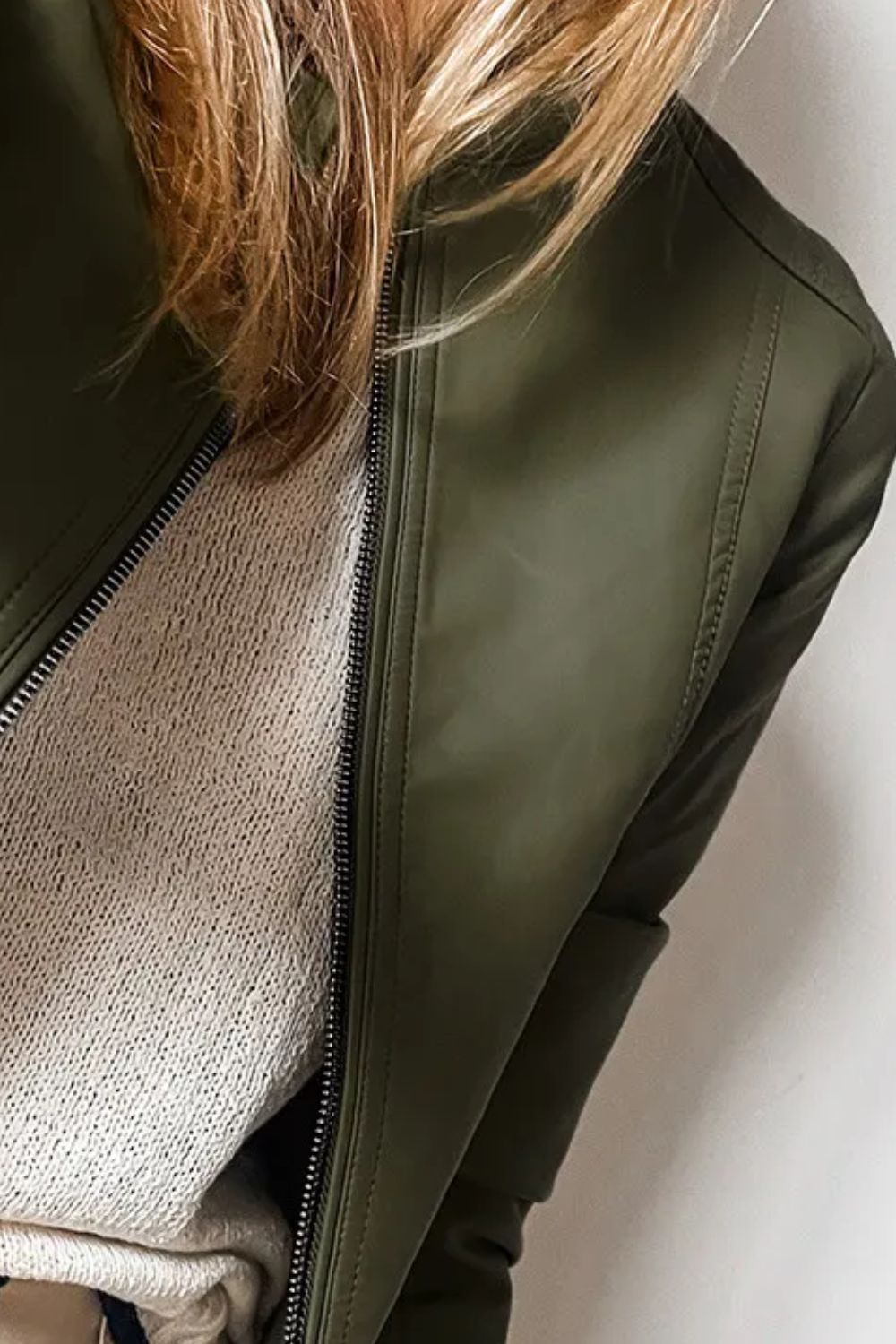 Side view of an olive green pleather jacket, perfect for fall.
